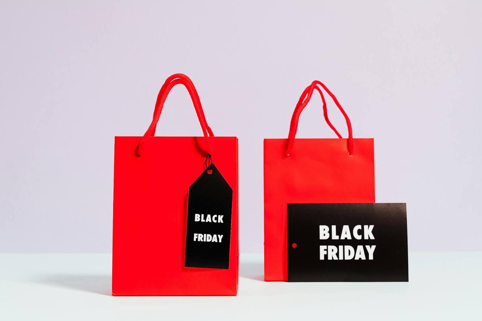 two red shopping bags with Black Friday tags on them