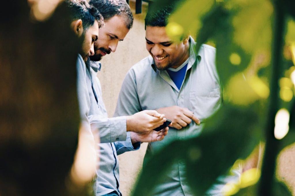 Men watching a video