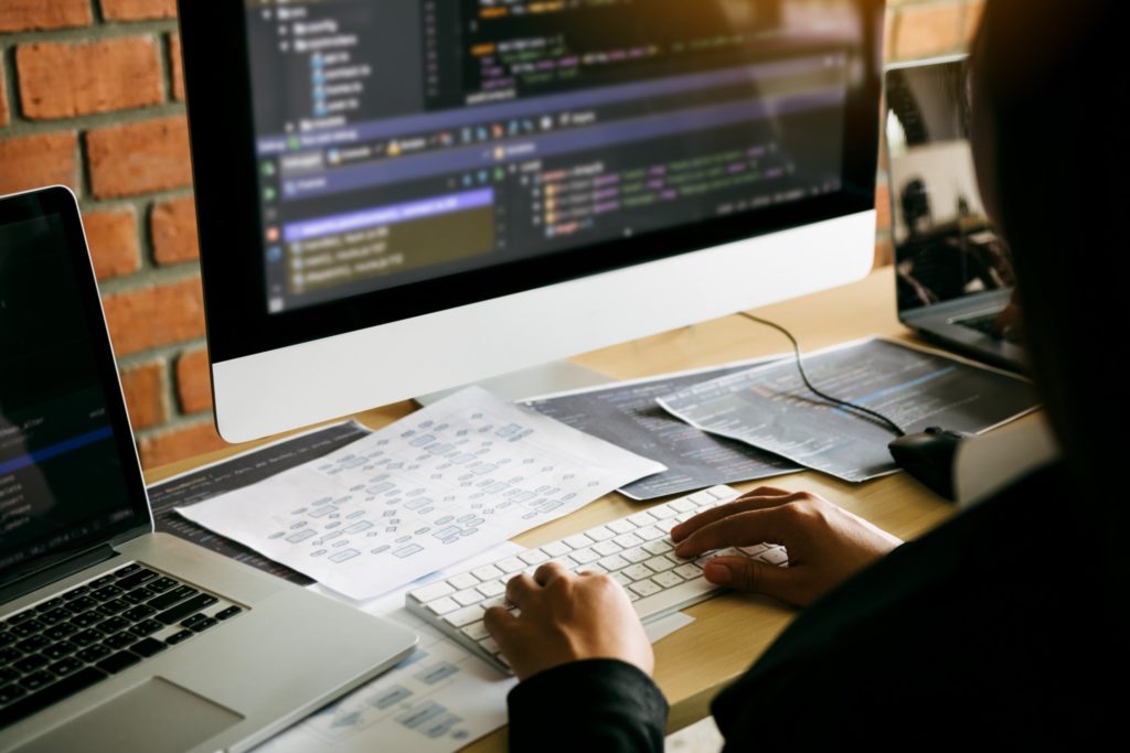 Man Typing on Keyboard