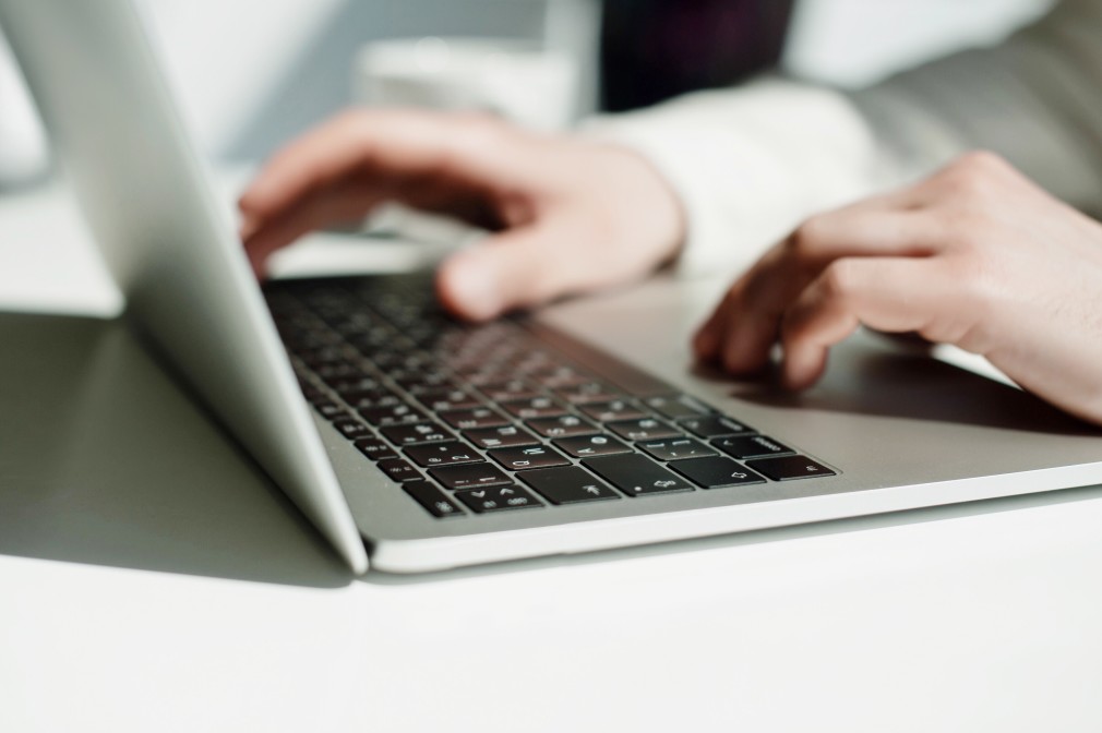 man's hand on a keyboard